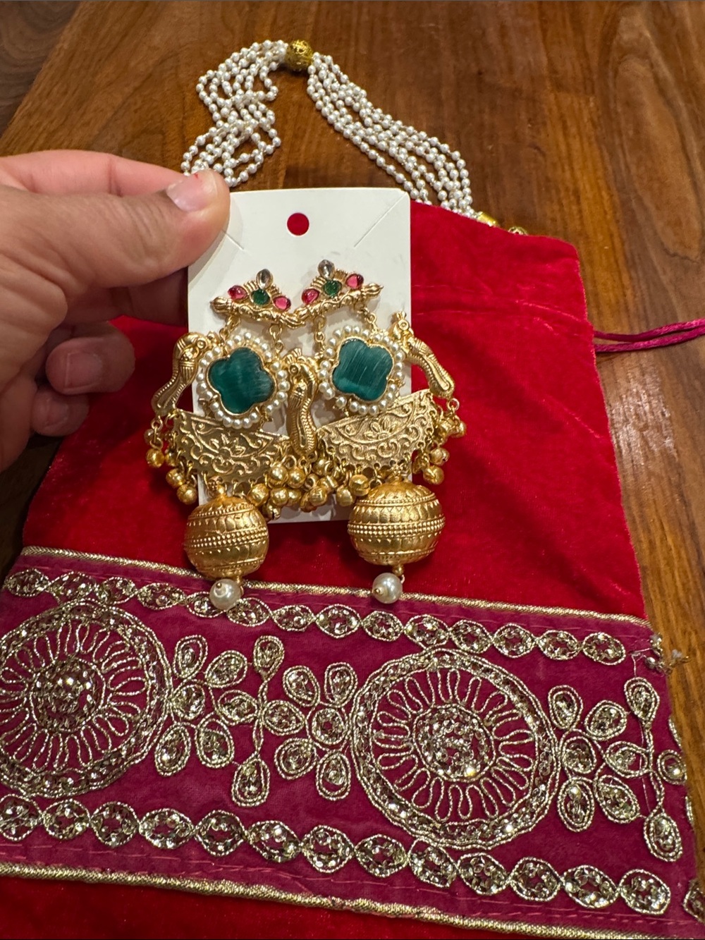 Gold-tone Jhumka Earrings with Green Stones with velvet large potli